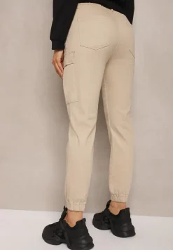 Beżowe Jeansy z Bawełny o Kroju Joggerów z Ozdobnymi Kieszeniami i Gumką w Pasie Unicella
